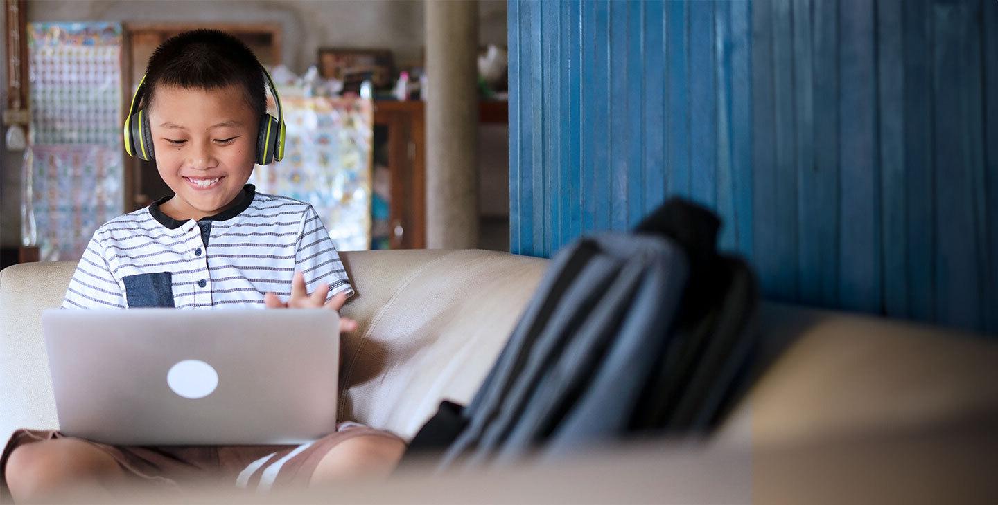 A boy on his laptop doing schoolwork using Viasat satellite internet